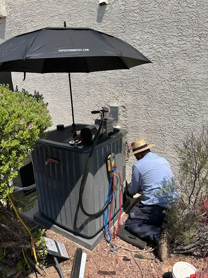HVAC technician performing outdoor AC maintenance in Hazel Crest